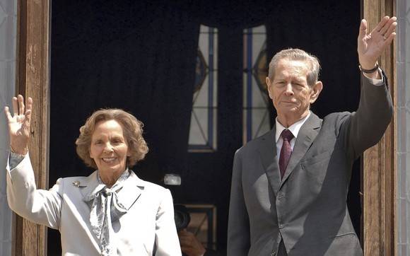 FILE - A Thursday, June 5, 2008 photo from files showing former Romanian King Michael I, right, and his wife Ana, left, as they wave from the balcony of the Peles Castle, in Sinaia, Romania. Romania's culture minister Kelemen Hunor said Wednesday, Feb. 17, 2010 in a letter to Parliament that Romania should purchase Peles castle from the country's former King Michael. Peles Castle was a royal residence until the communists came to power in 1947 and Michael was forced to abdicate. The castle was handed back to Michael in 2007. (AP Photo/Paul Buciuta, File)
